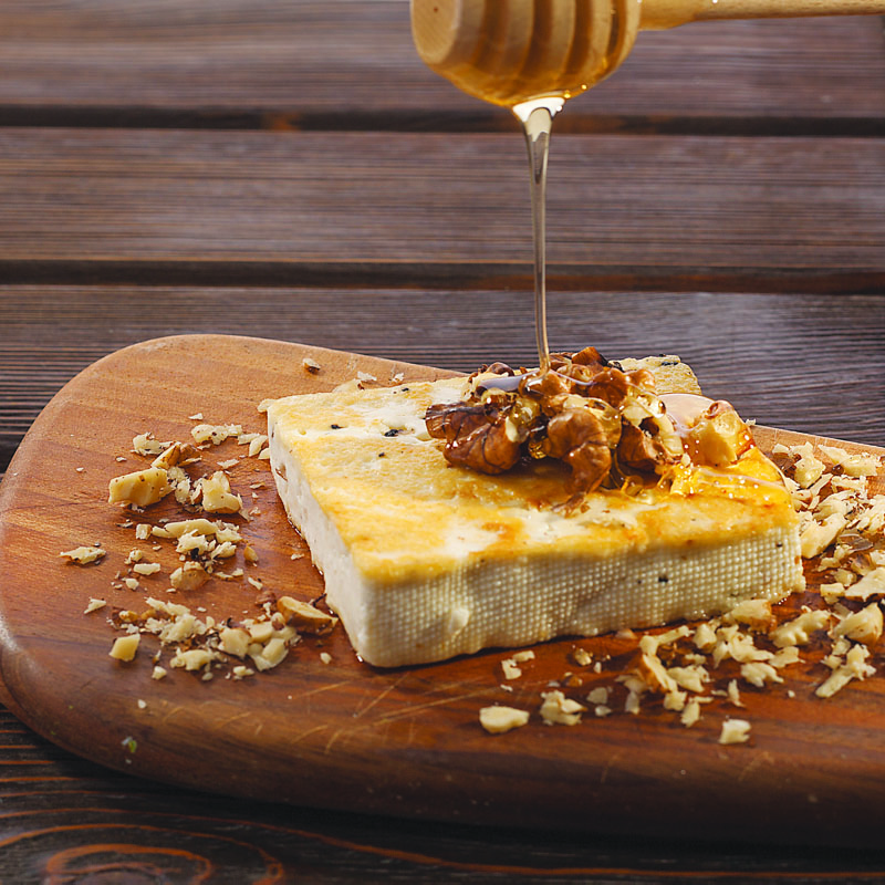 Grilled Goat’s Milk Cheese with Truffle, Honey, and Walnuts